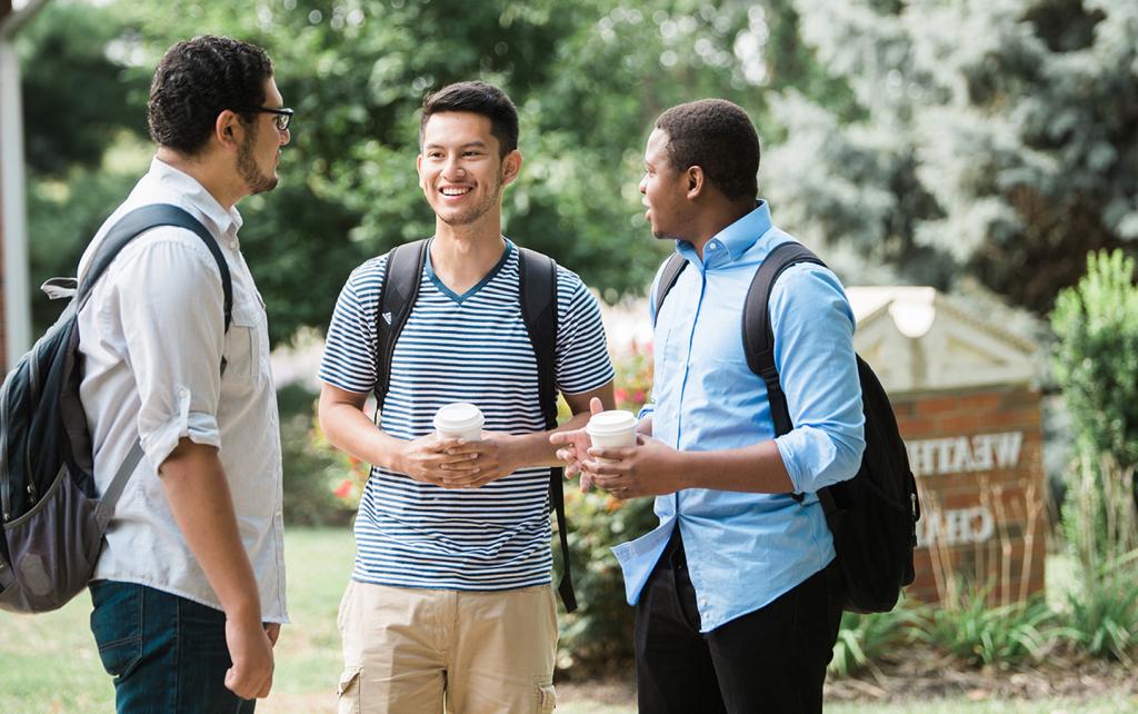 Group of students talking outside of a chapel